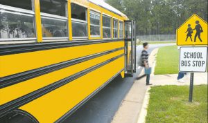 kid stepping off school bus
