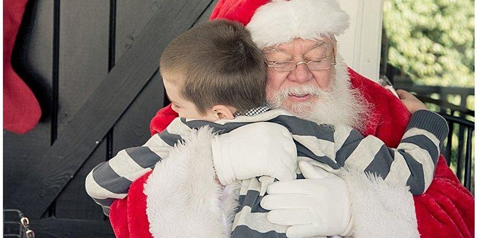 hamburg: santa hugging a young boy with a stripped shirt