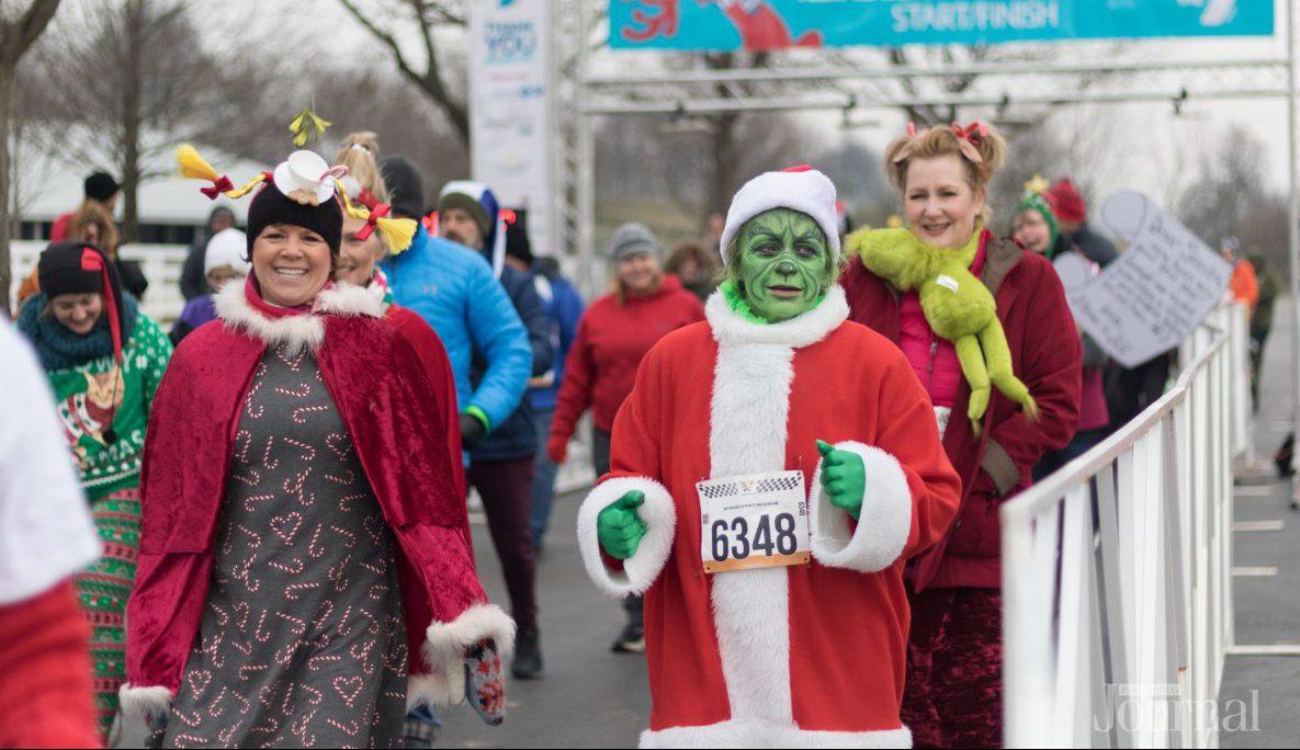 Holiday Guide: group of people dressed in christmas outfits running a race