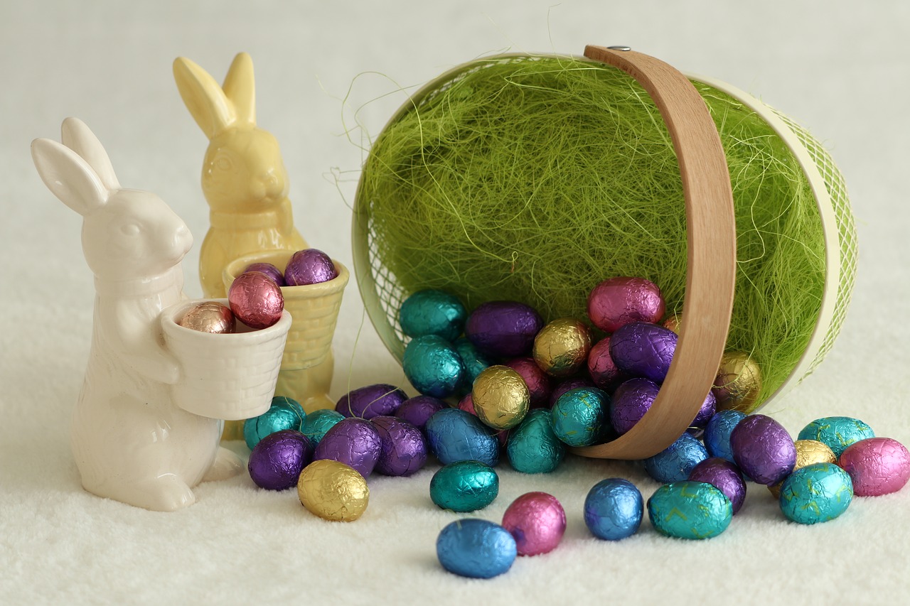 Easter Service Egg Hunts: small basket with chocolate eggs falling out and two porceling bunnies