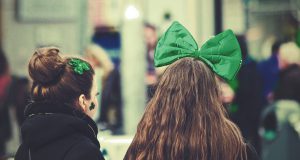 Two women with green bows in their hair
