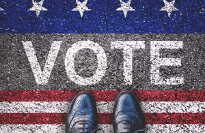 Primary Election Elections: vote written in chalk with blue and red and white and a pair of shoes