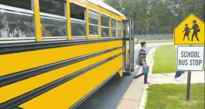 kid stepping off school bus