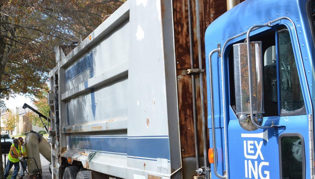 blue and silver garbage truck wiht lexington in white on the door