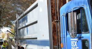 blue and silver garbage truck wiht lexington in white on the door