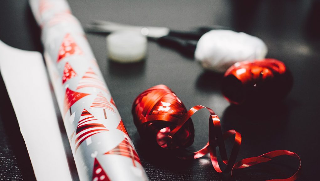 holiday: silver and red wrapping paper with scissors and ribbon