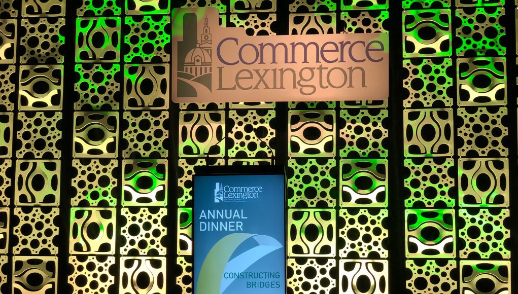 commerce lexington logo and a green backdrop