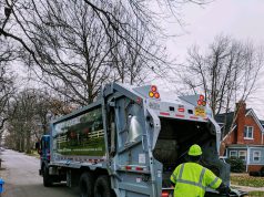 Presidents’ Day: a garbage truck and a trash collector putting a herbie to dump in the truck