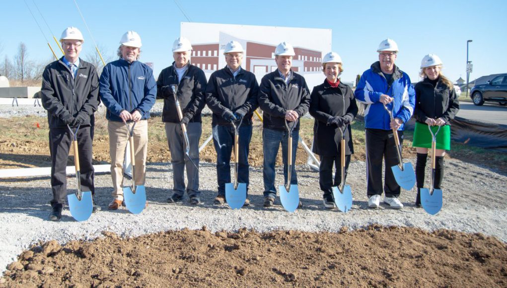 business news: group of people with shovels posing for a picture