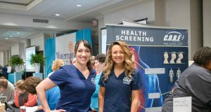 Health: two women dressed in scrubs smiling at the camera