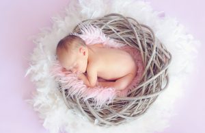 Mother's Day: a baby in a basket sleeping