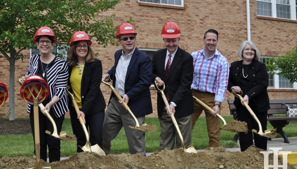 Senior: group of people in hard hats with shovels possing