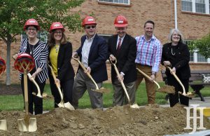 Senior: group of people in hard hats with shovels possing