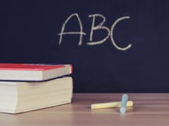 FCPS: chalkboard that says ABC and chalk and books on a table