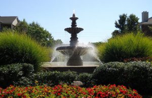 Apartment Complex: a fountain surrounded by flowers