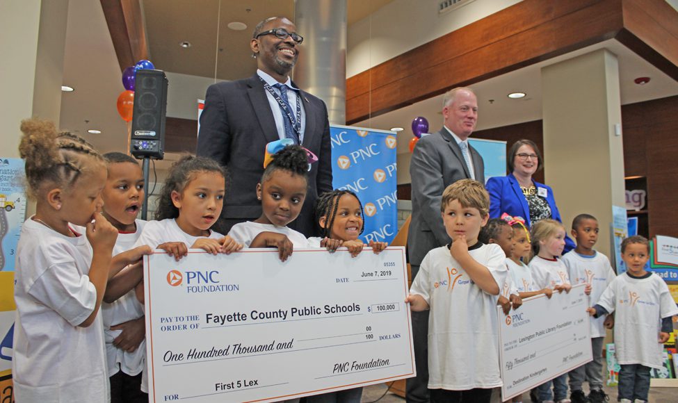 Parents Fayette County Public Schools: group of adults and kids holding up big checks