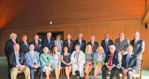 Business Hall of Fame: group of people sitting and standing smiling at the camera