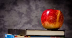 merit scholarships school Parents: blackboard with books on a desk and an apple