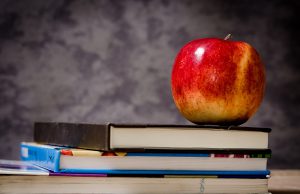 merit scholarships school Parents: blackboard with books on a desk and an apple