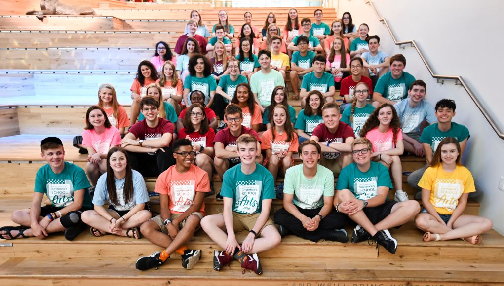 Kentucky: group of kids in different color shirts sitting on large steps