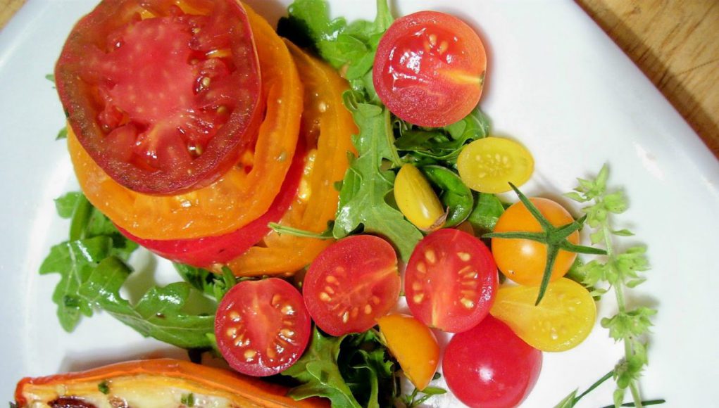 Chef Tom: tomatoes, lettuce, and other foods on a white plate