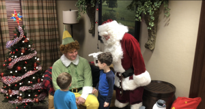 family holiday guide Neighborhood: a man dressed as elf and santa claus with kids