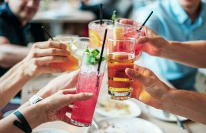 bars: group of people cheersing with alcoholic drinks